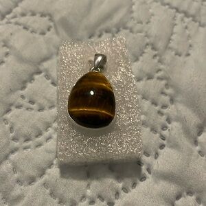 Chatoyant golden tiger’s eye cabochon set in .925 sterling silver, New